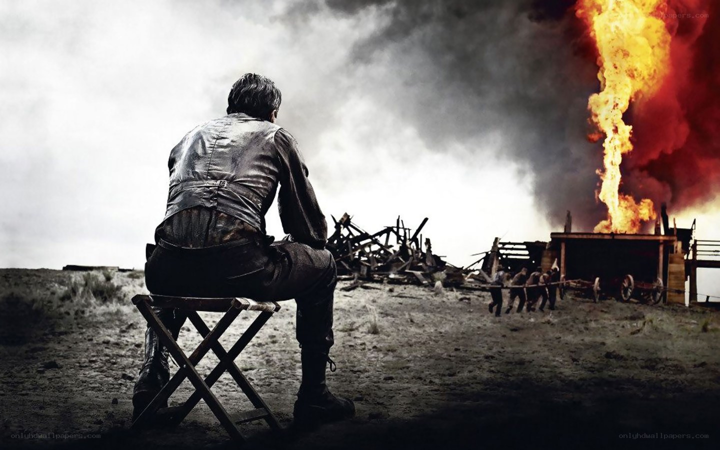 Man watches burning settlement