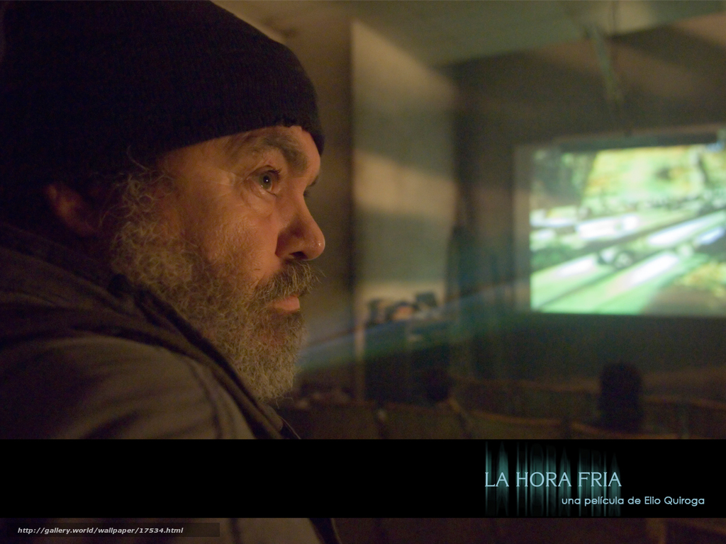 man watching film in dark room