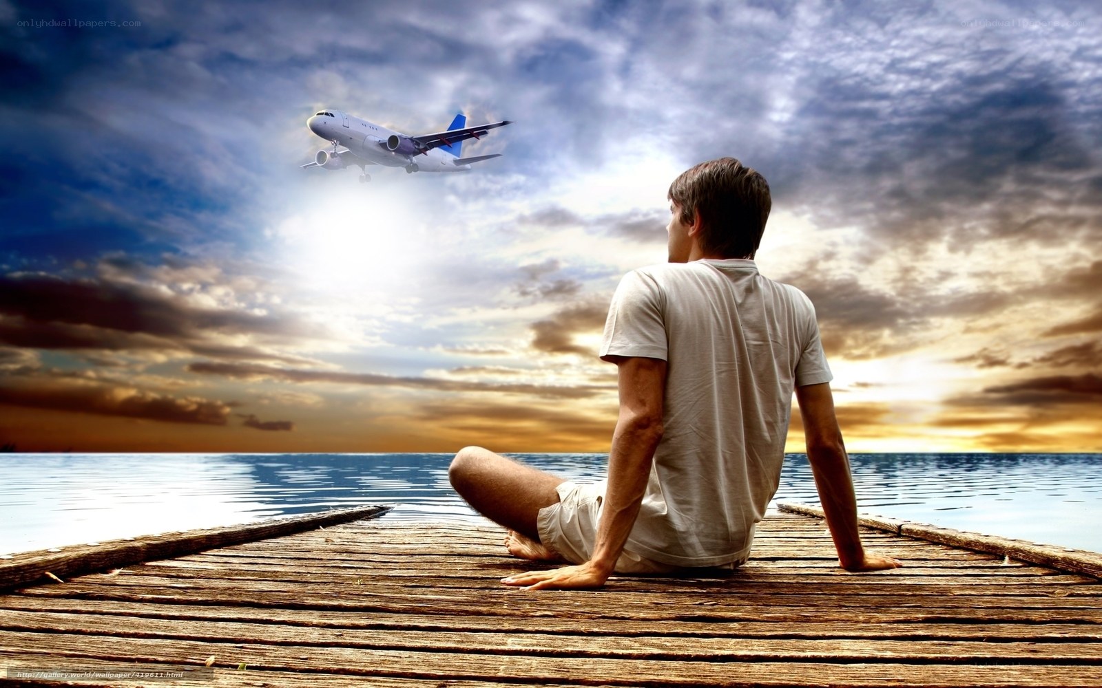Man watching plane at sunset