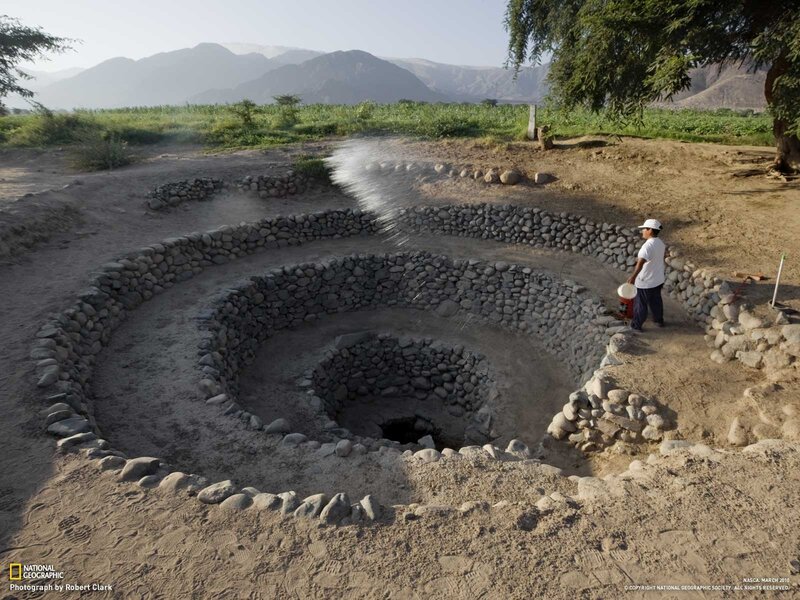 Man watering ancient well