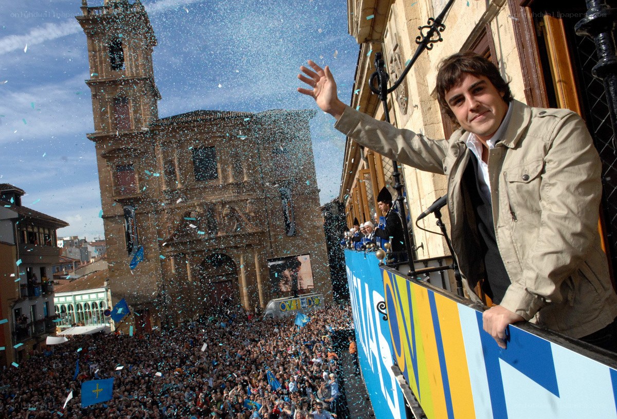 Man waving at crowd from balcony