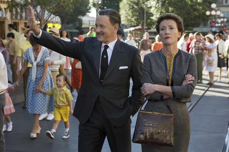 Man waving at crowd with woman