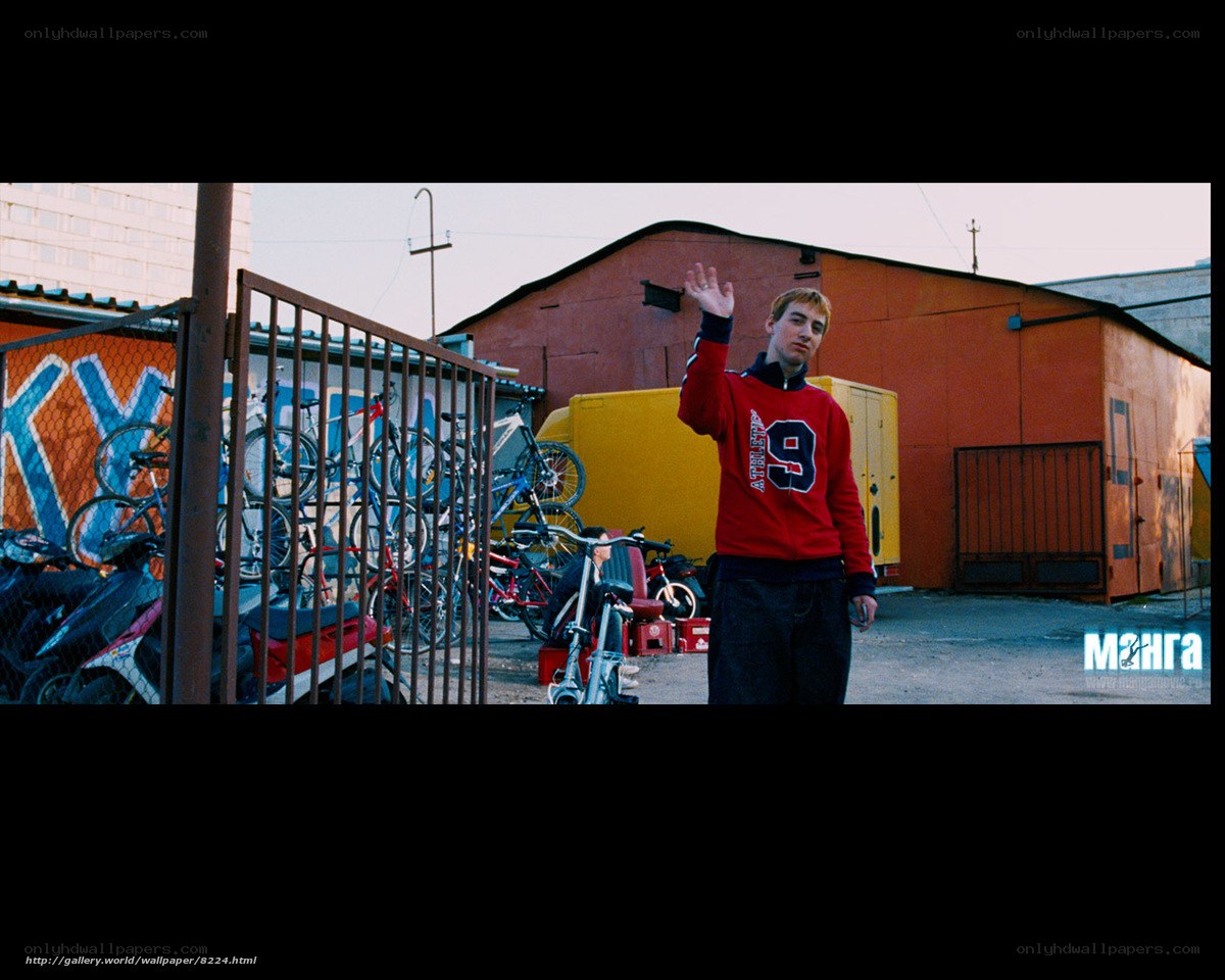Man waving in urban alley