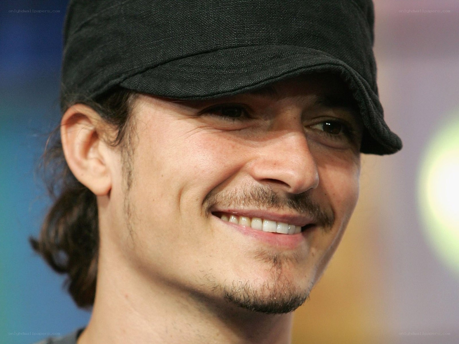 man wearing black cap smiling