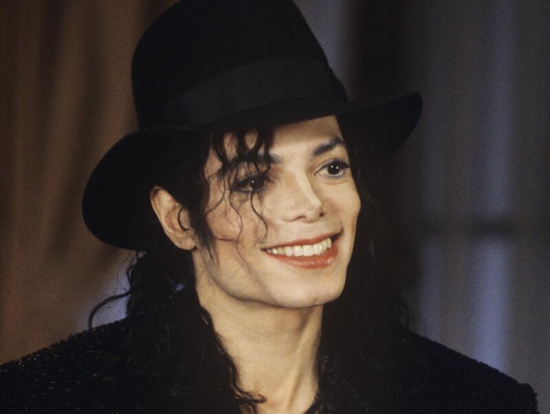 Man Wearing Black Hat — Smiling