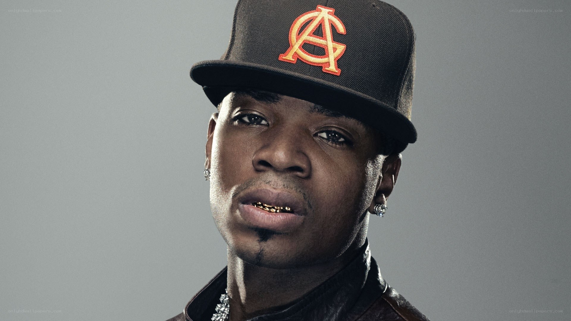 man wearing cap and gold teeth