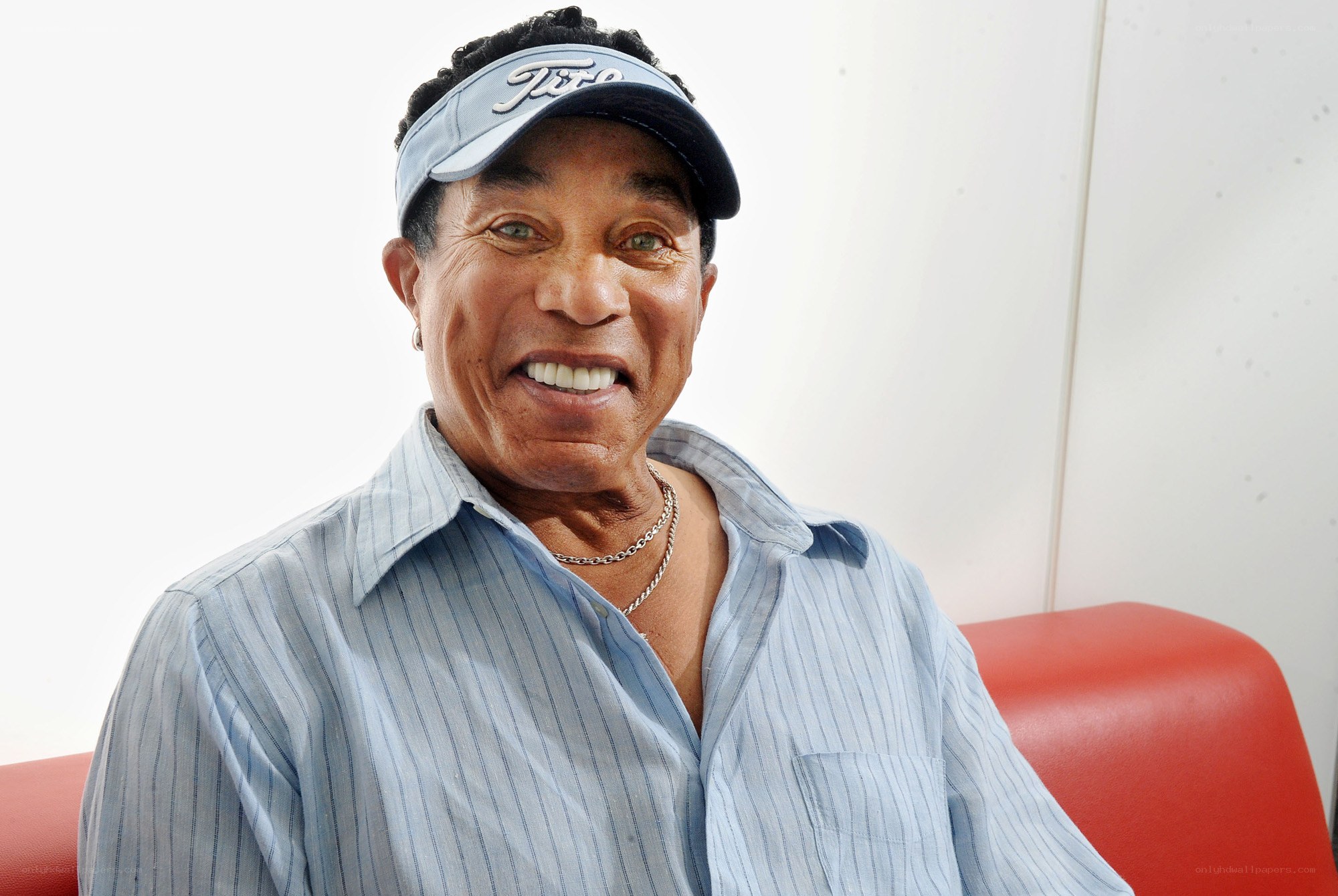 man wearing cap and striped shirt