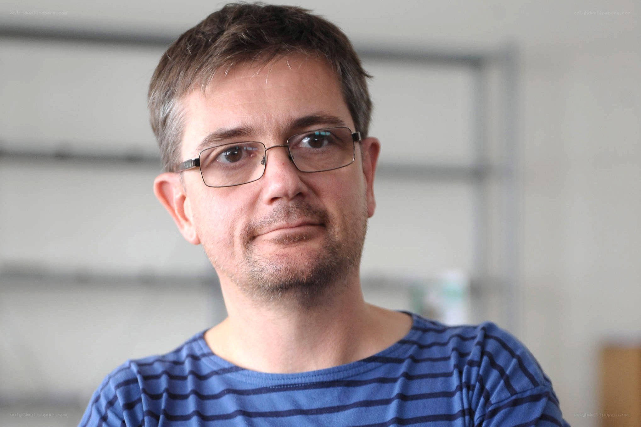 man wearing glasses and striped shirt