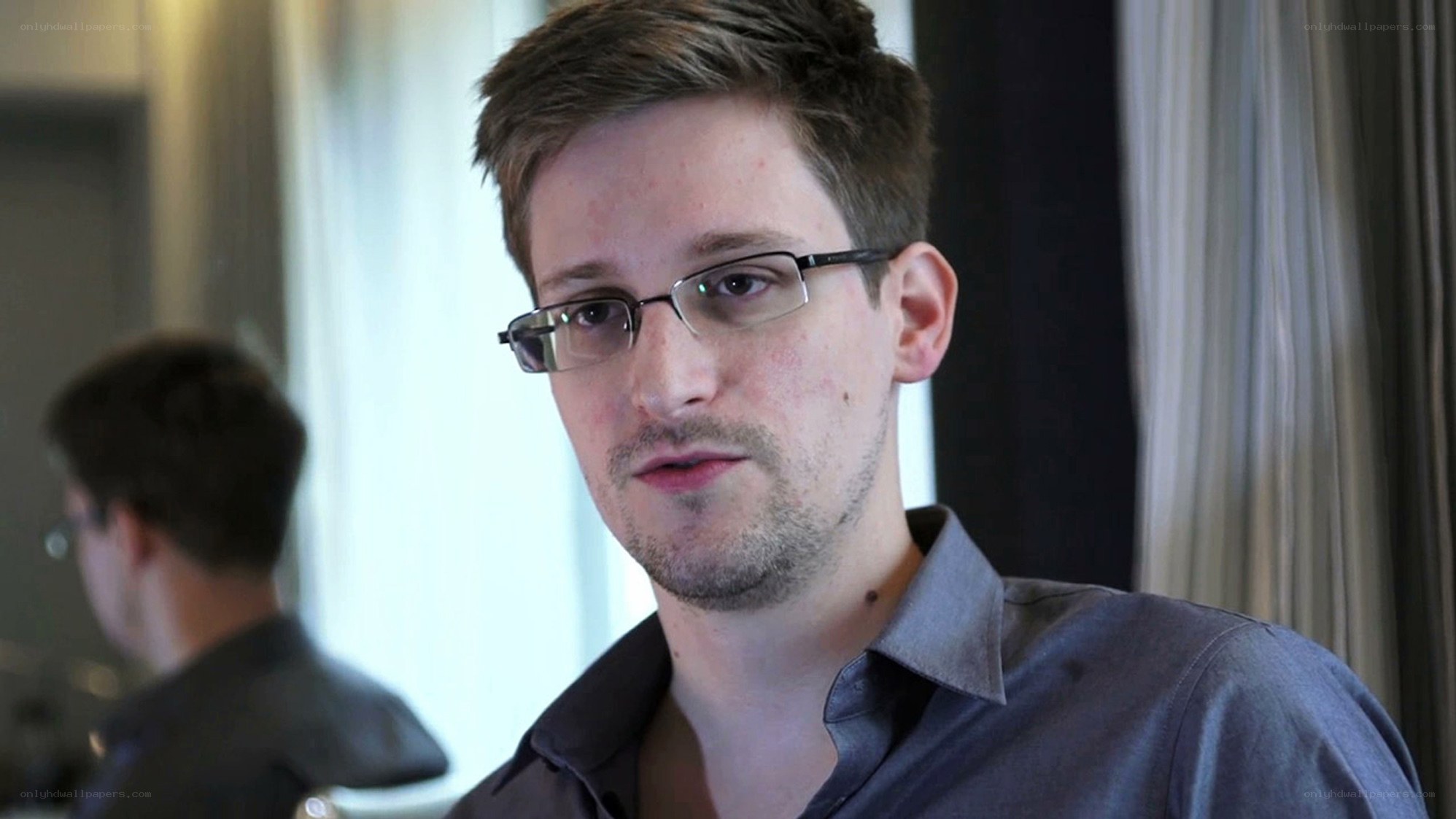 man wearing glasses in room