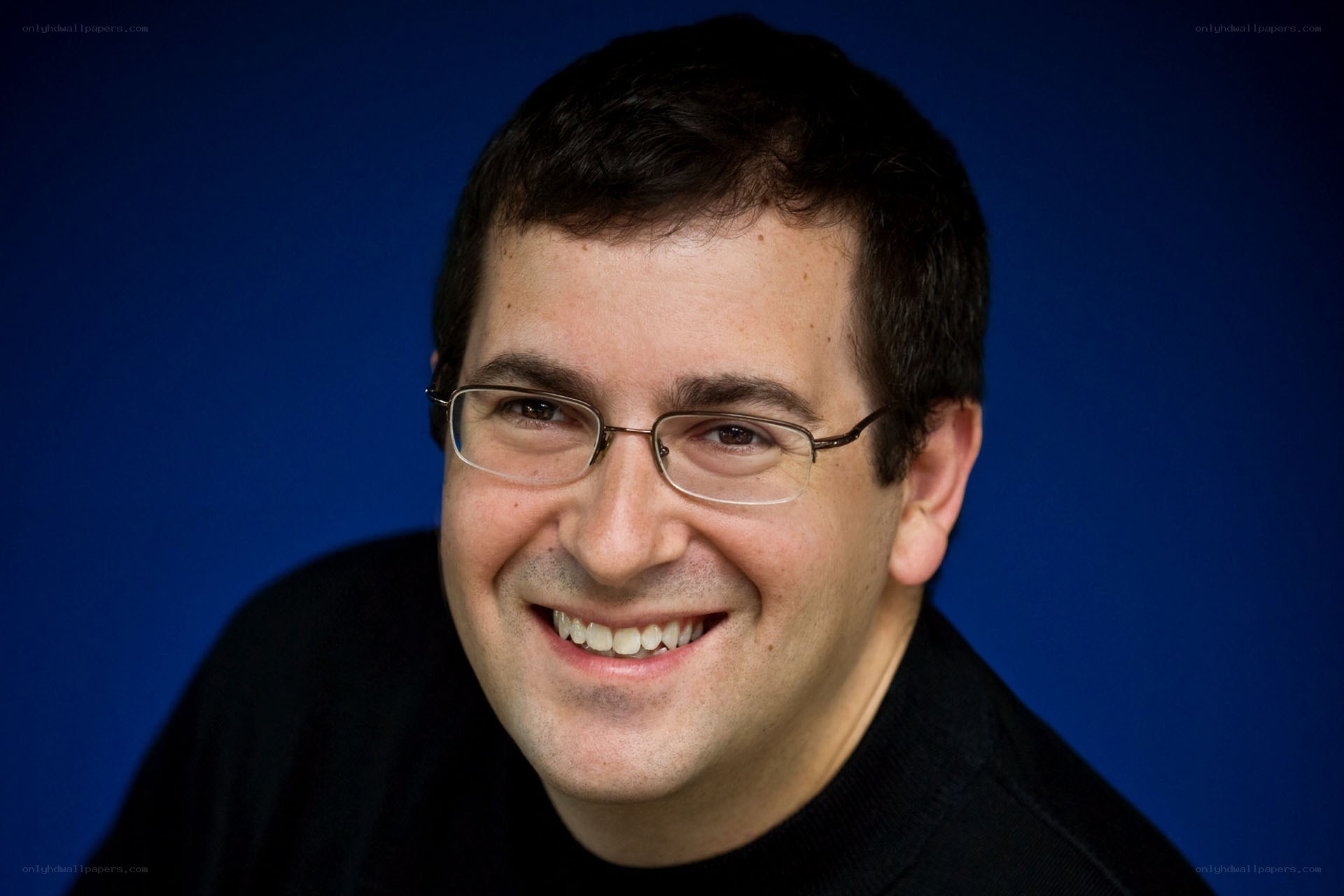 man wearing glasses smiling