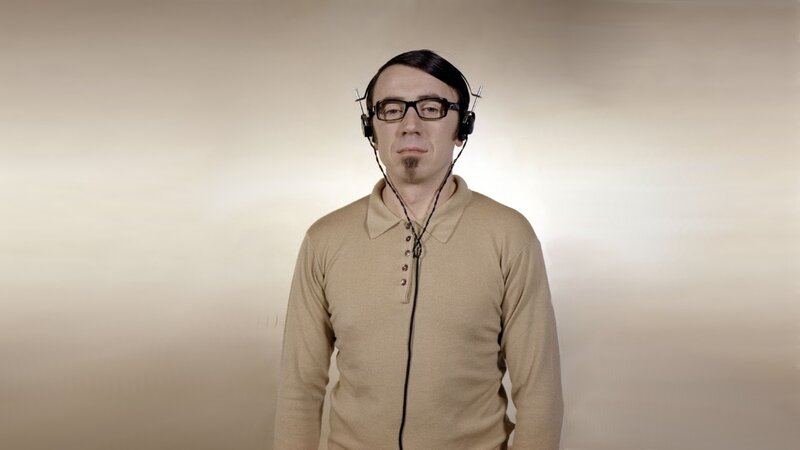 Man wearing headphones and glasses