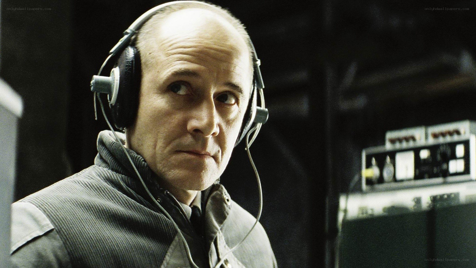 man wearing headphones in control room
