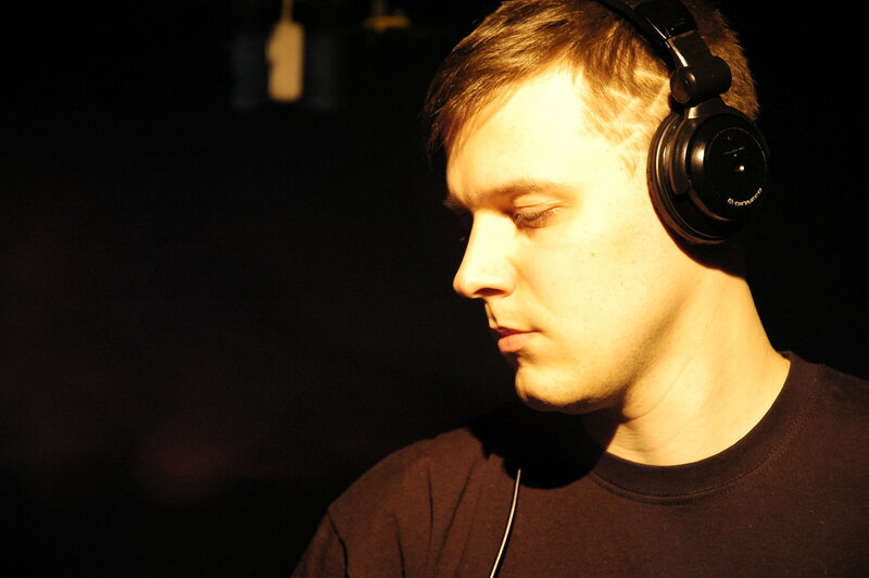 man wearing headphones in dark room