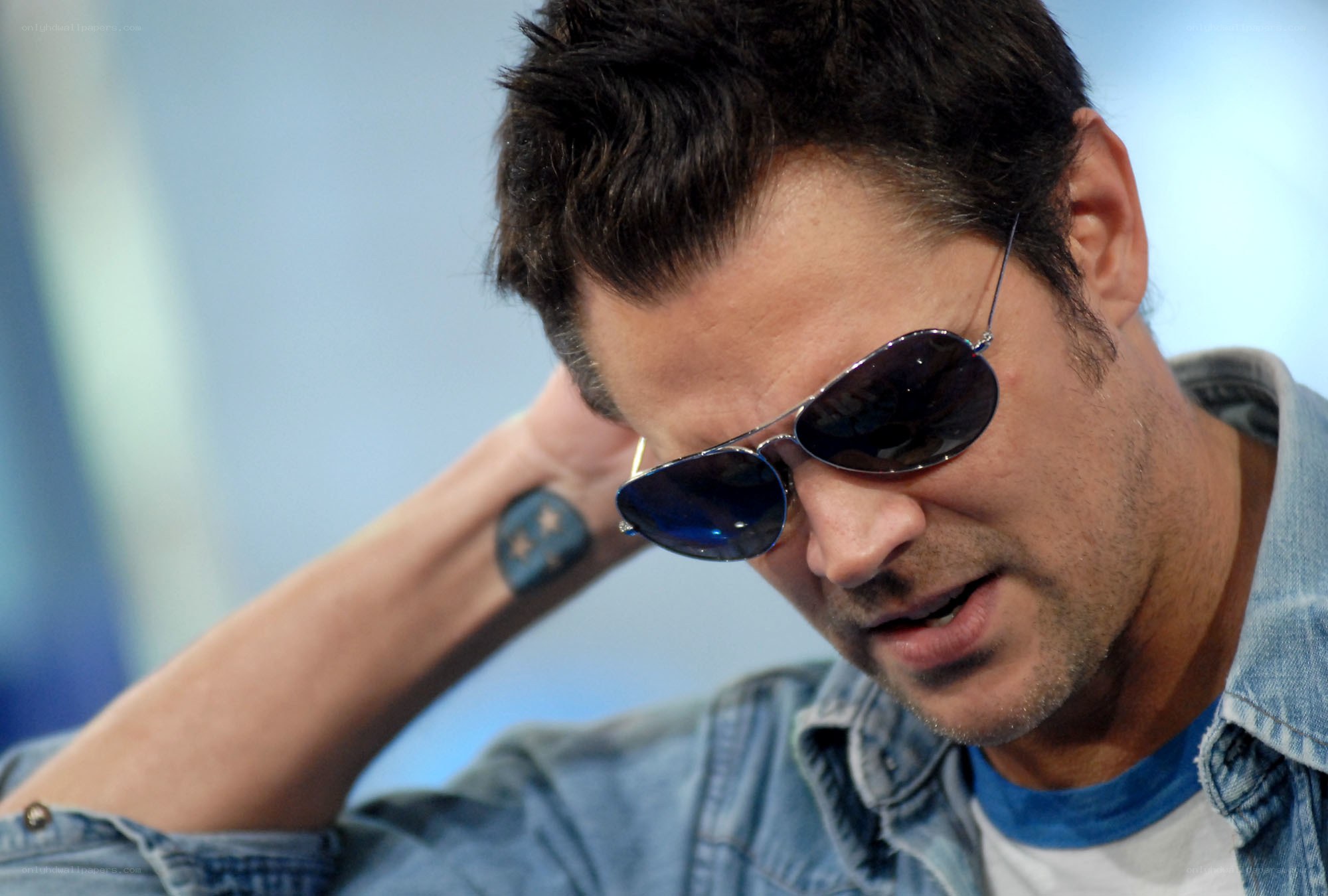 man wearing sunglasses and denim