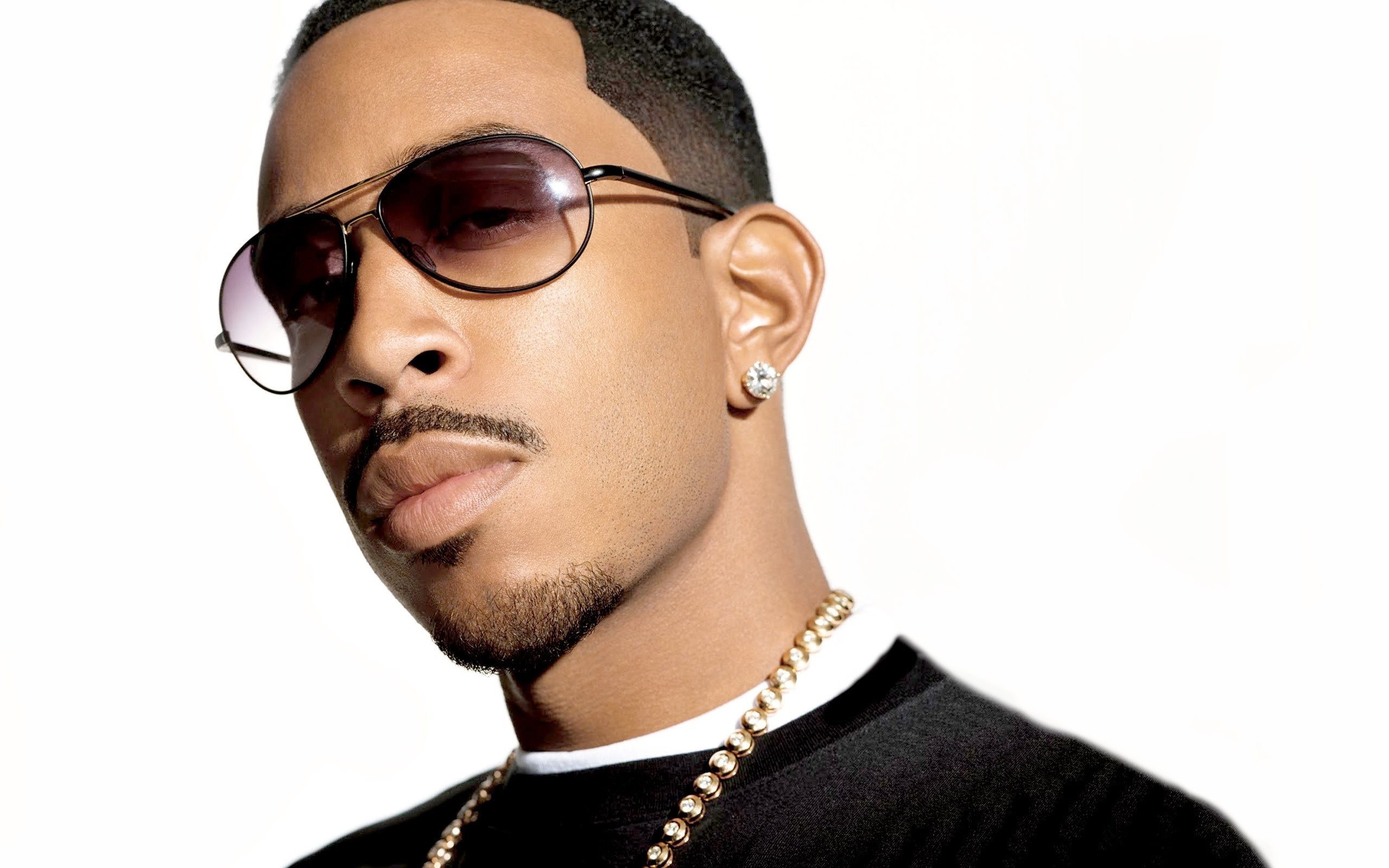 man wearing sunglasses and gold chain