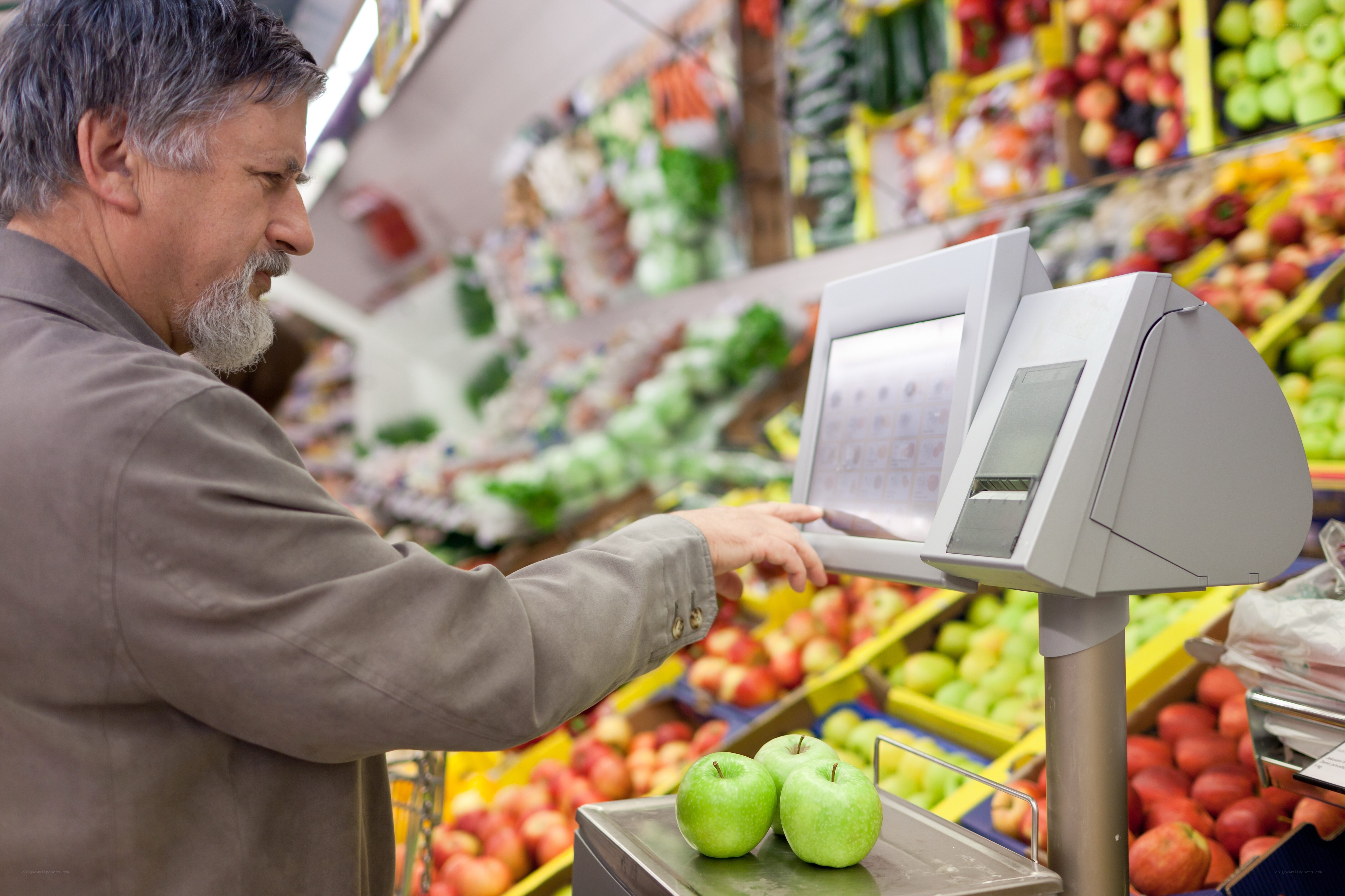 man weighing apples at market