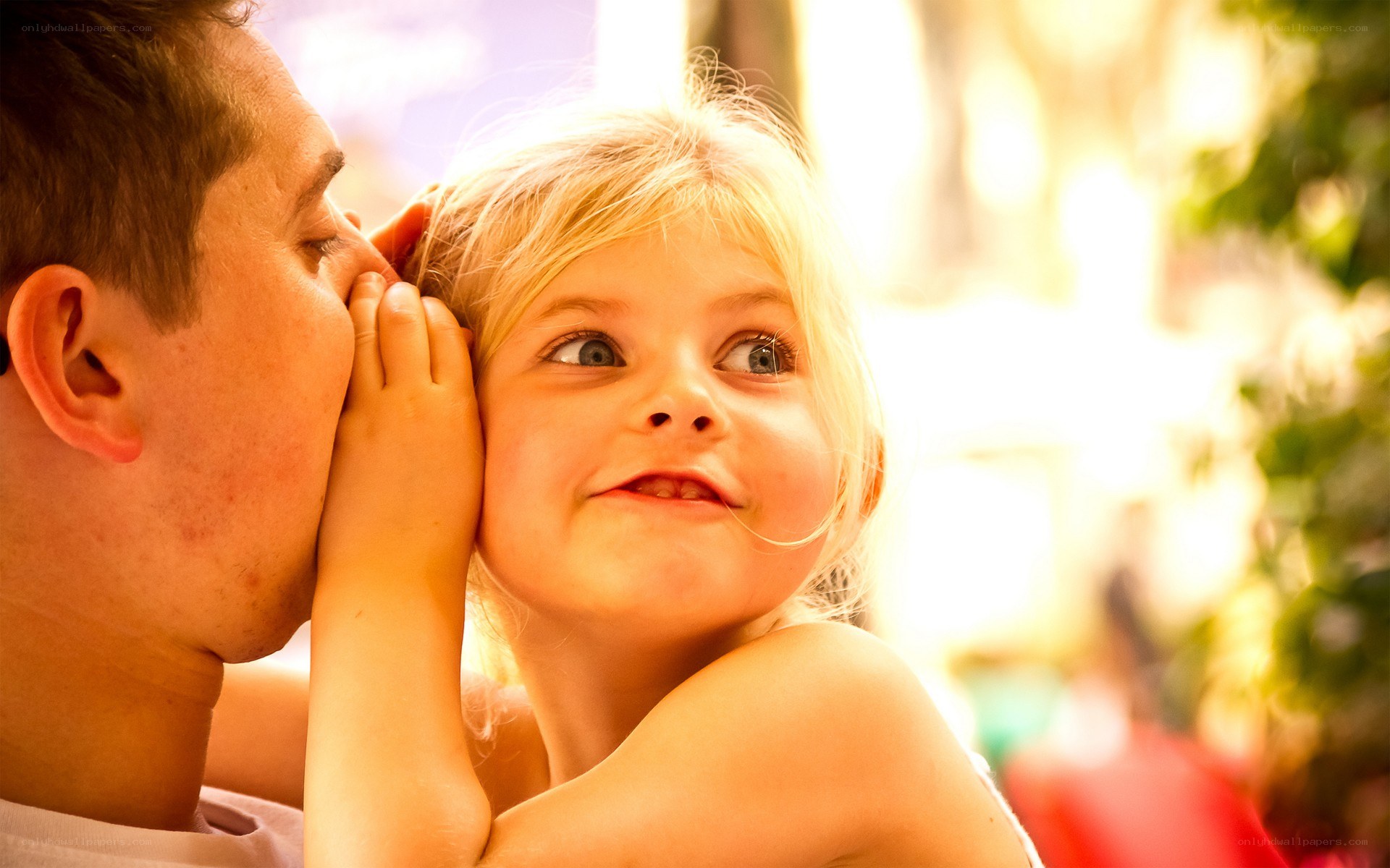 man whispering to child