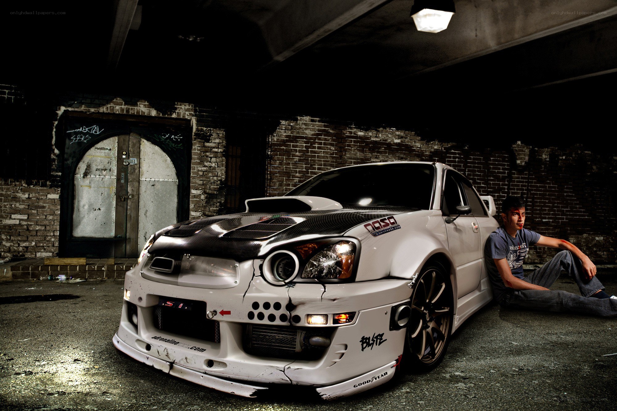 Man with a damaged race car