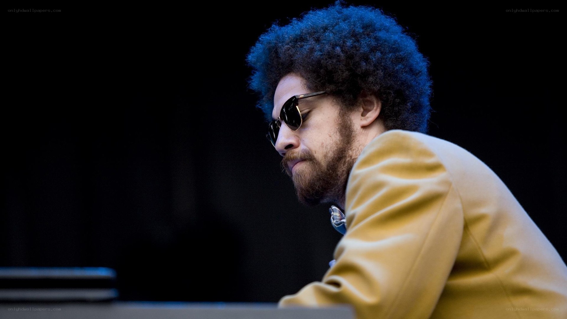 man with afro playing piano