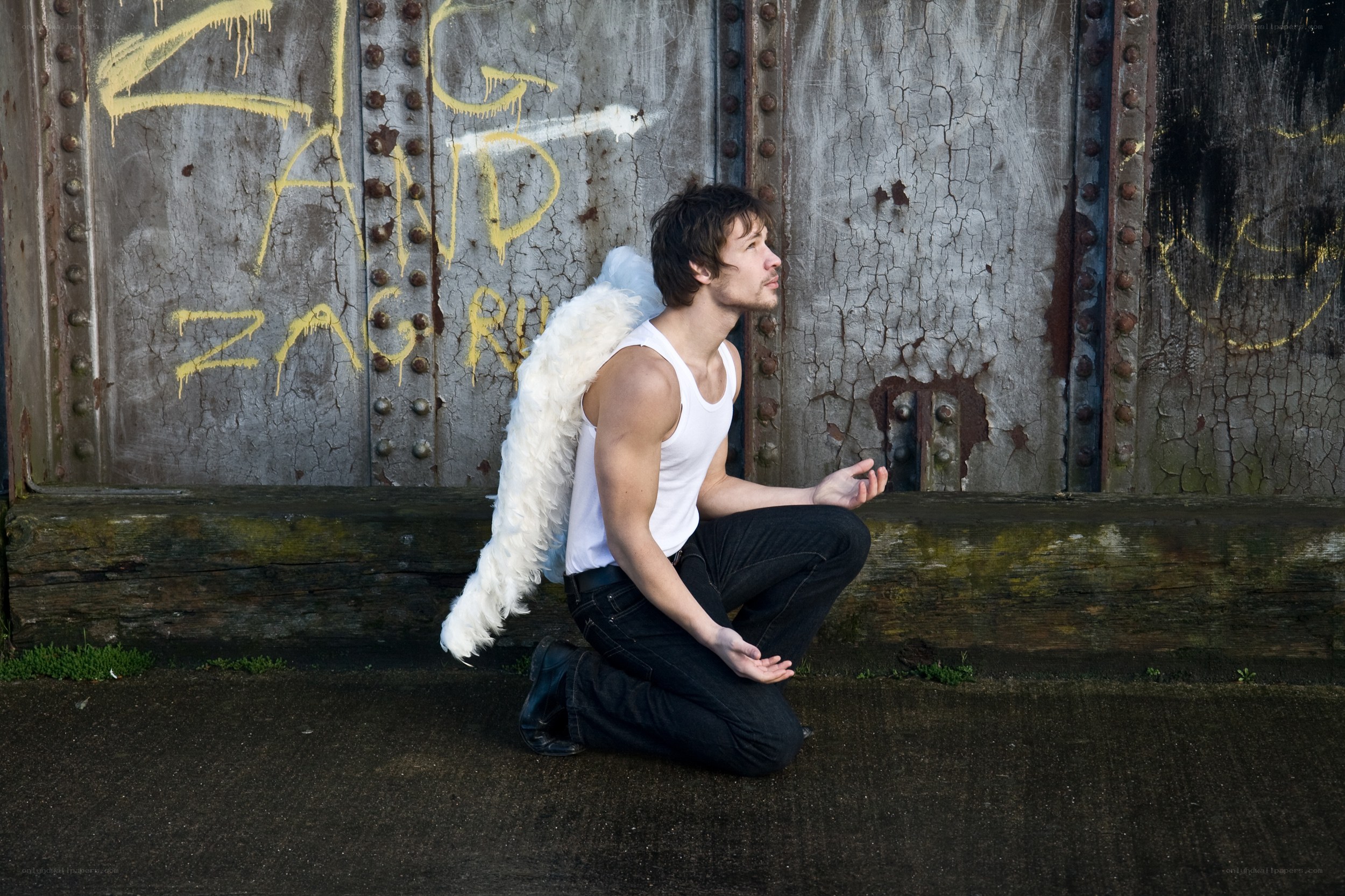 man with angel wings kneeling