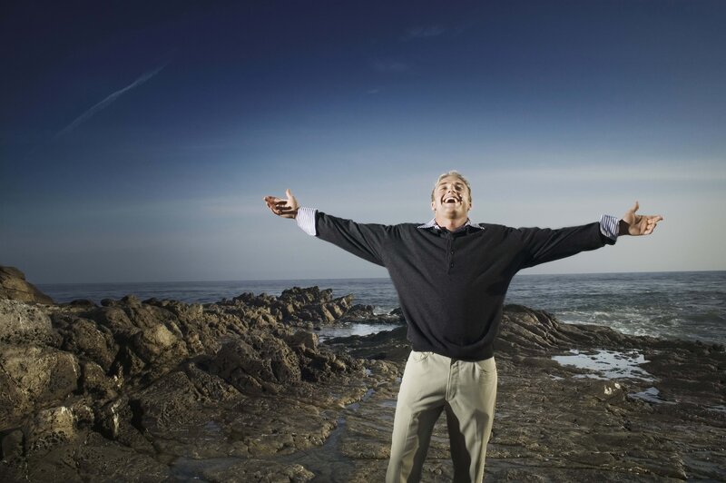 Man with arms outstretched at the beach