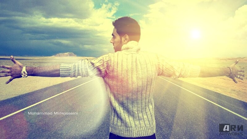 man with arms outstretched on road