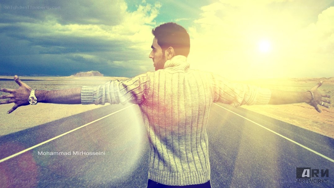 man with arms outstretched on road