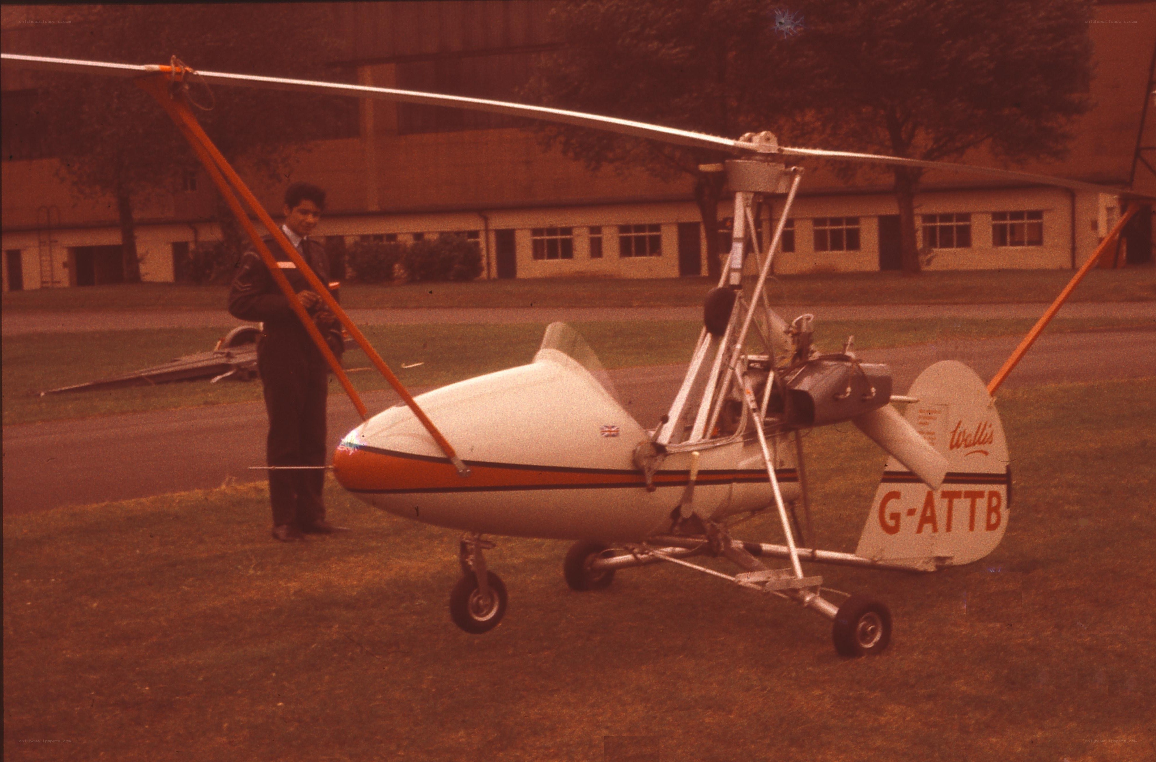 Man with autogyro on grass