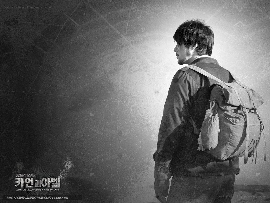 man with backpack in black and white
