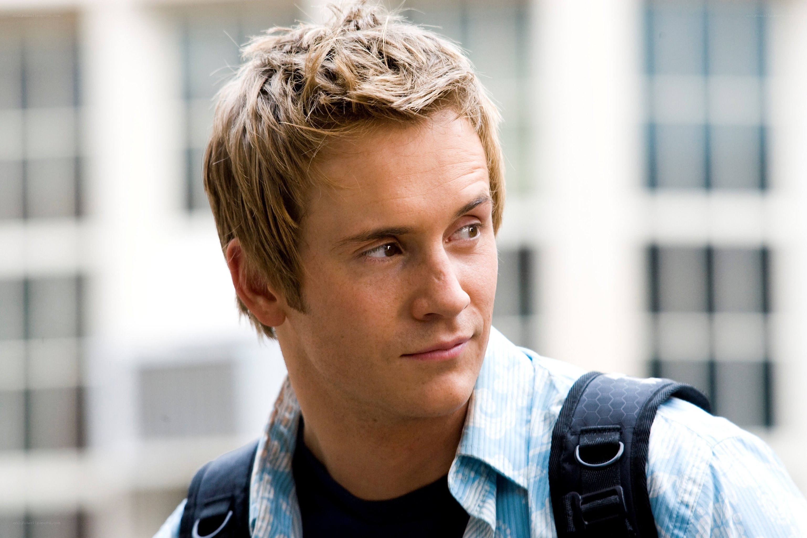 man with backpack looking away