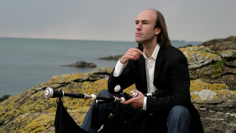 Man with bagpipes by the sea