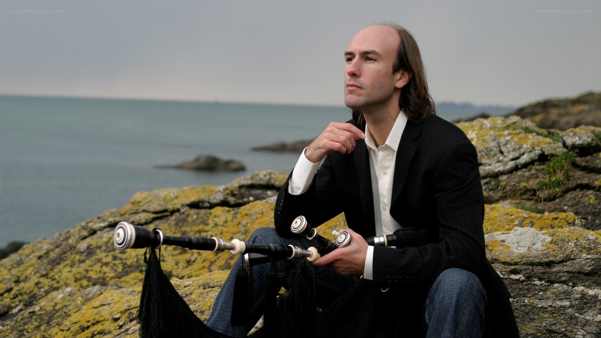 Man with bagpipes by the sea