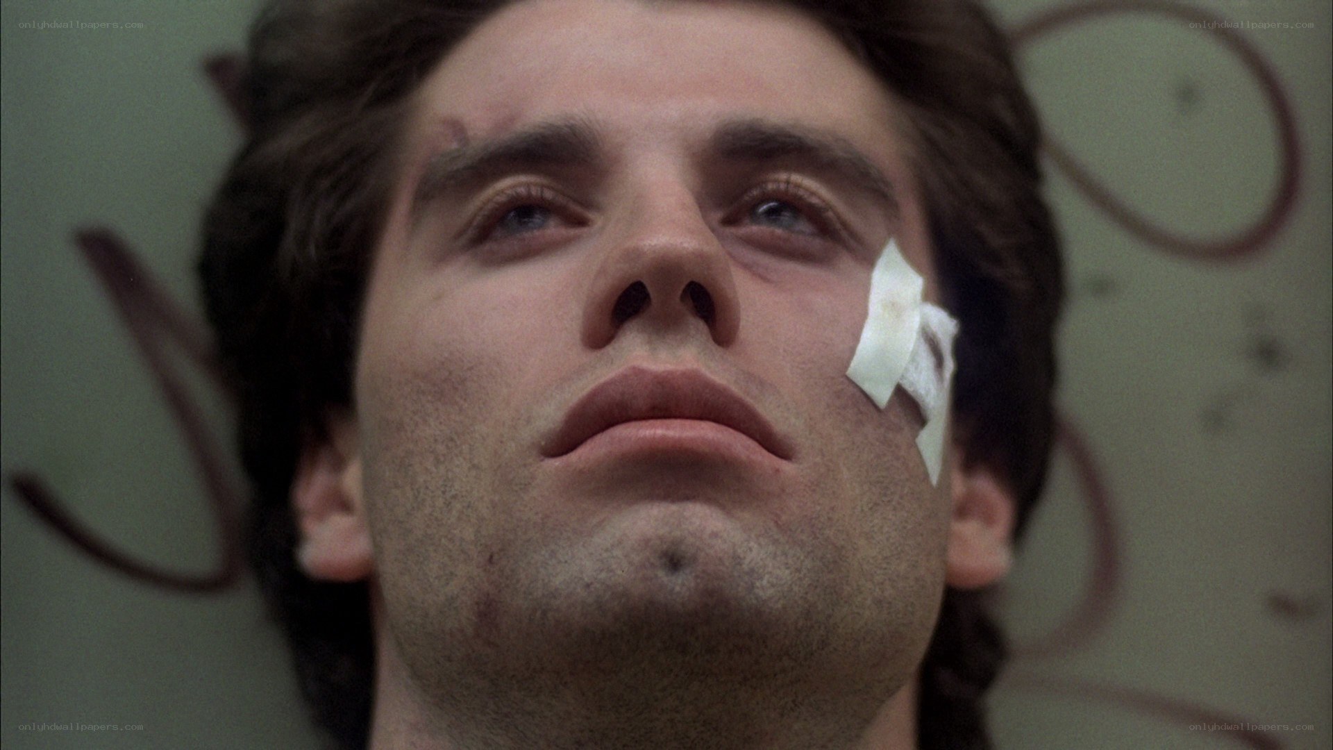 man with bandage on face
