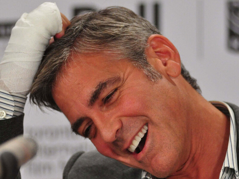 man with bandaged hand laughing