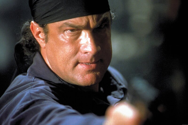 man with bandana holding gun