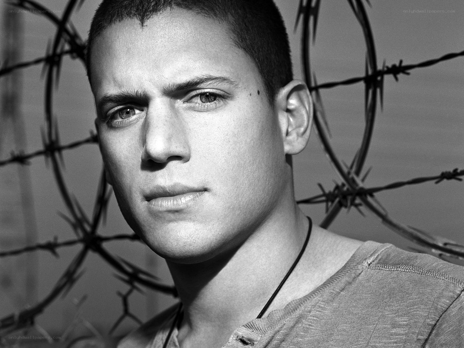 man with barbed wire background