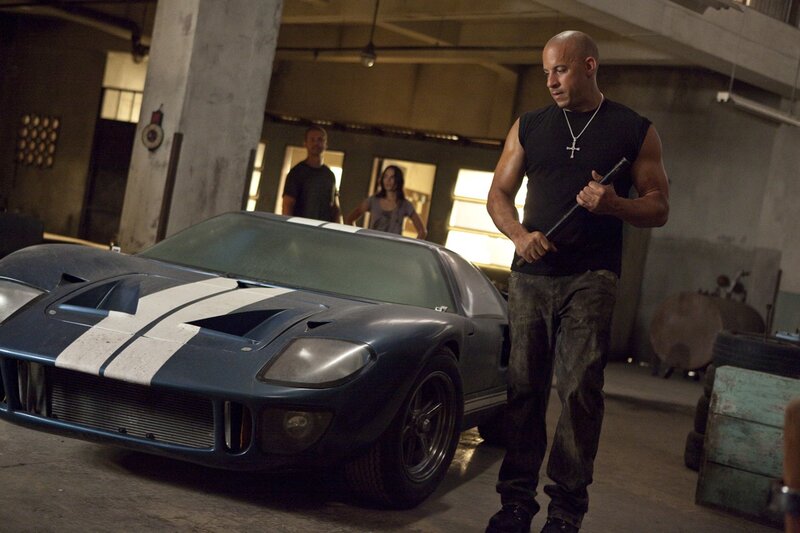 Man with bat near classic car