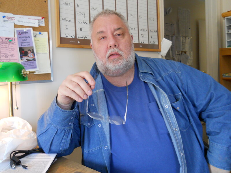 Man with Beard Holding Glasses
