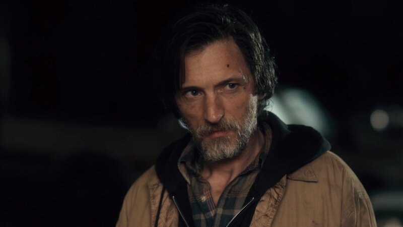 man with beard in dark setting