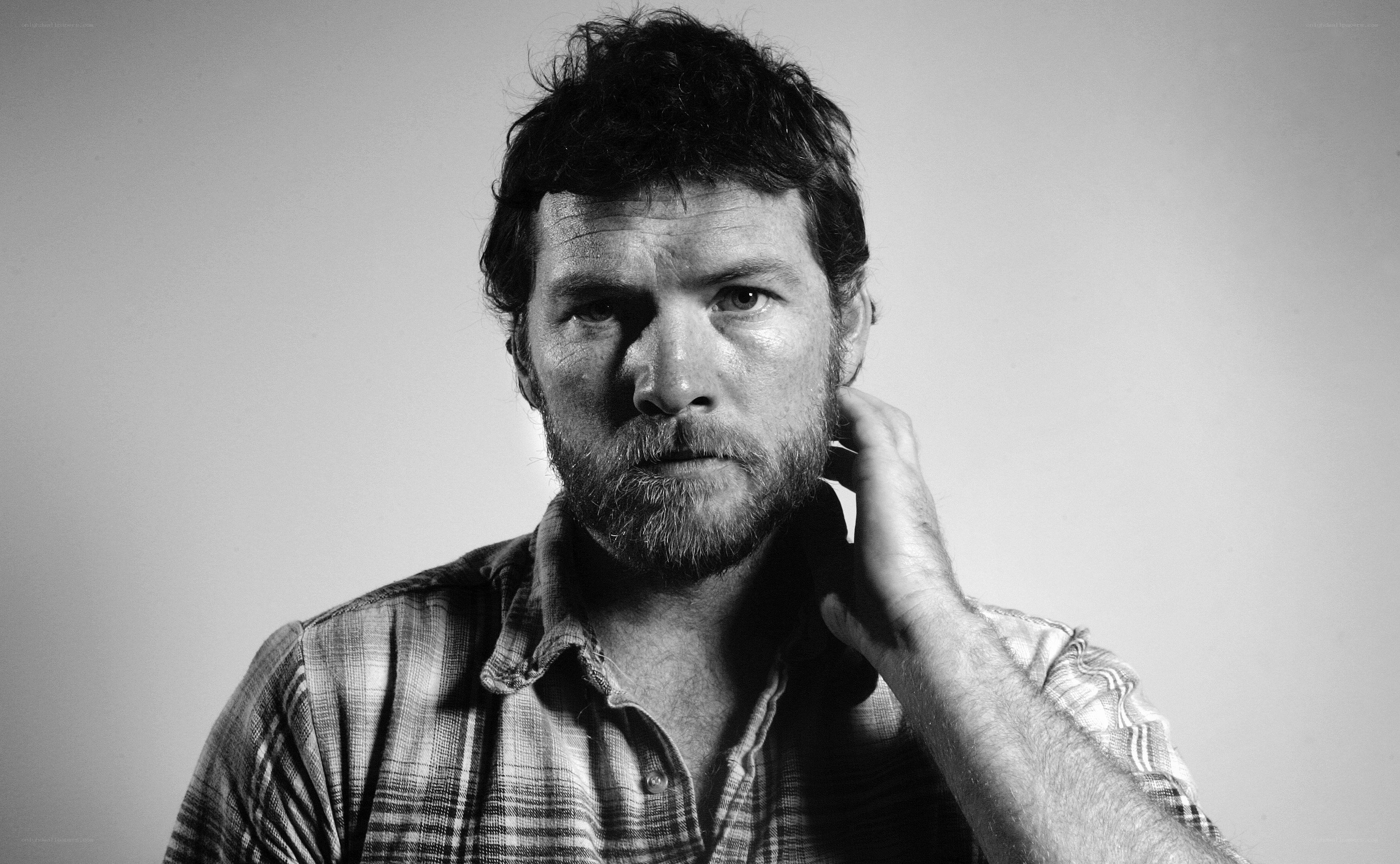 man with beard in plaid shirt