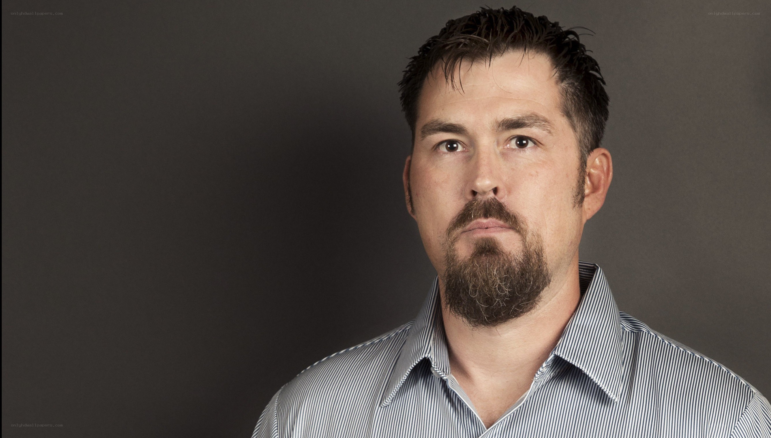 man with beard in striped shirt