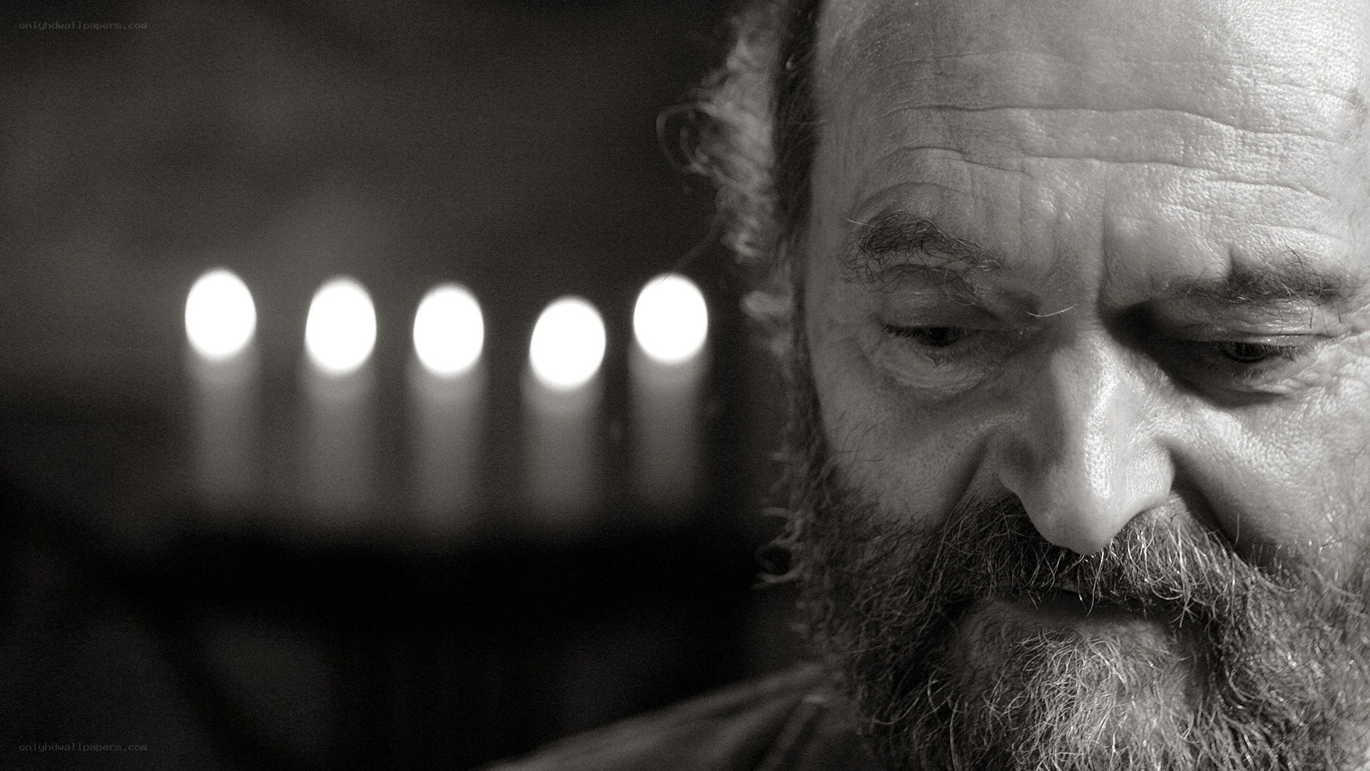 man with beard looking down