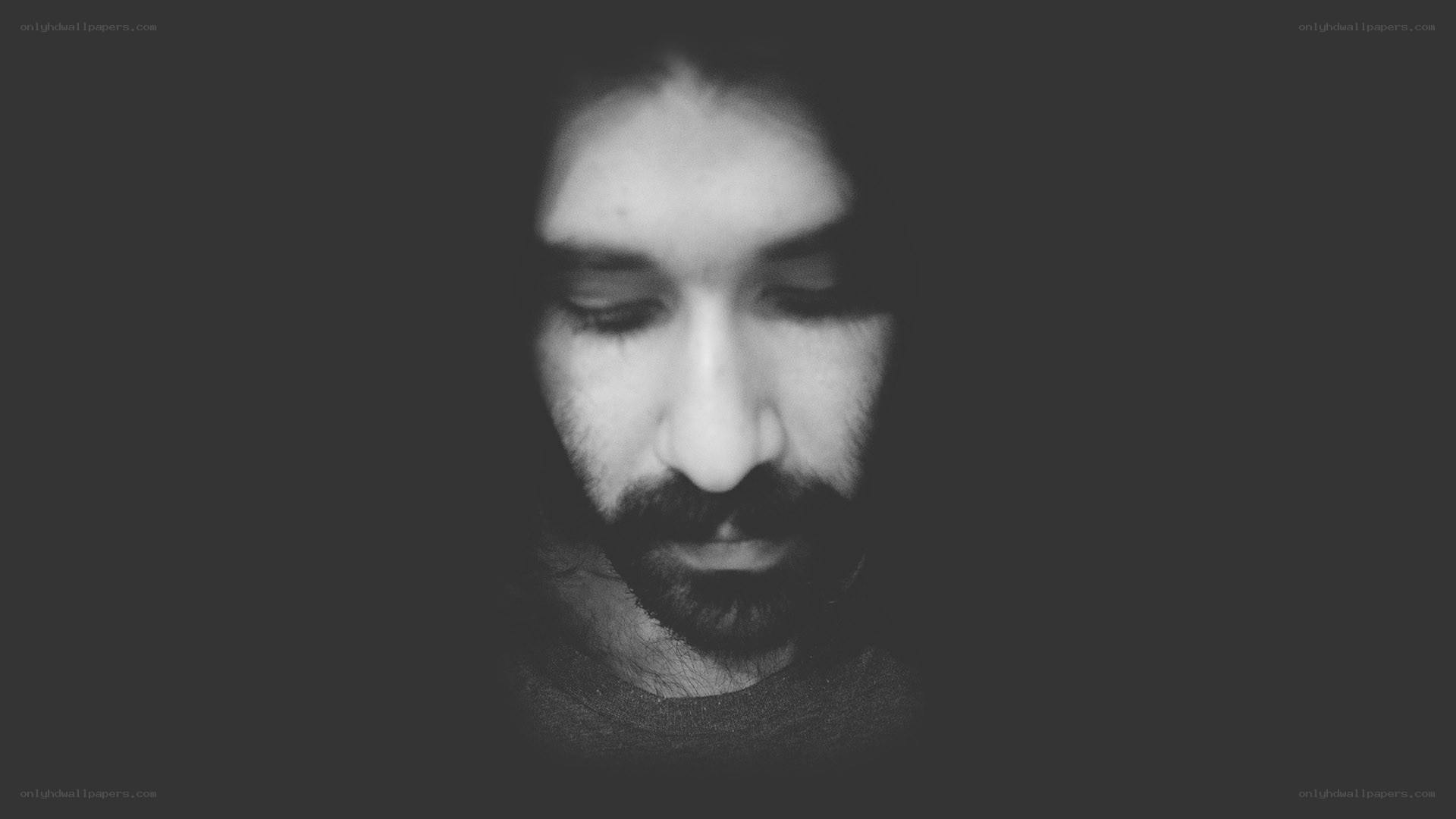 man with beard looking down