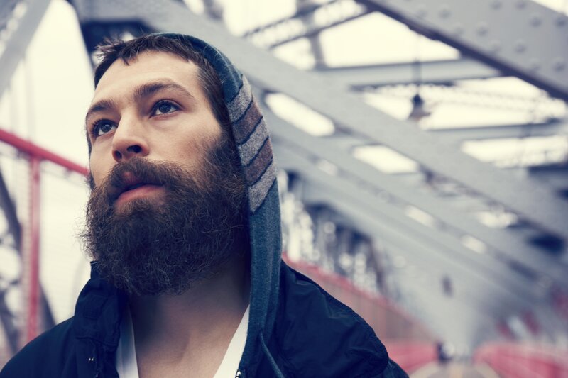 man with beard on bridge