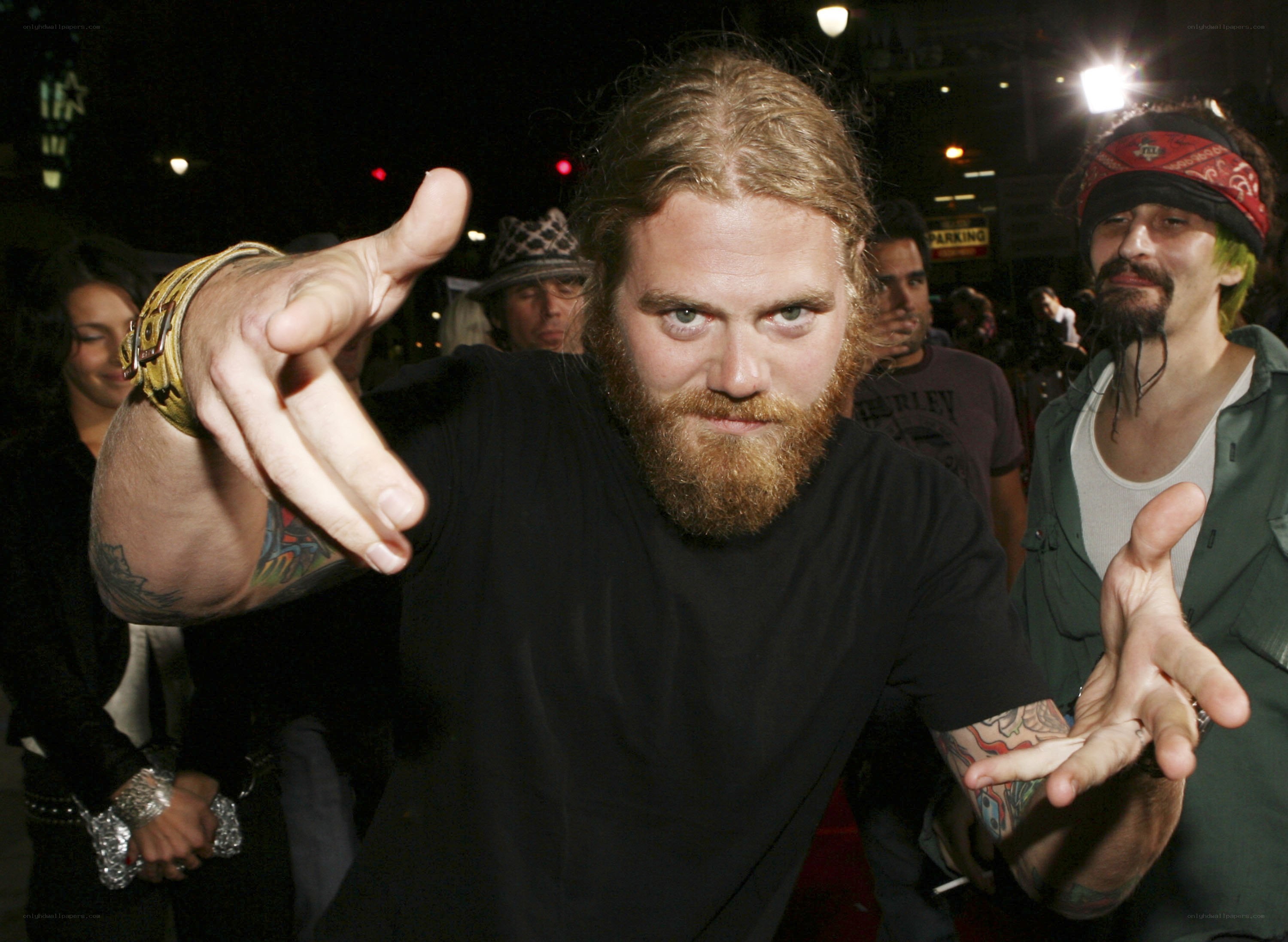 Man with beard pointing at camera