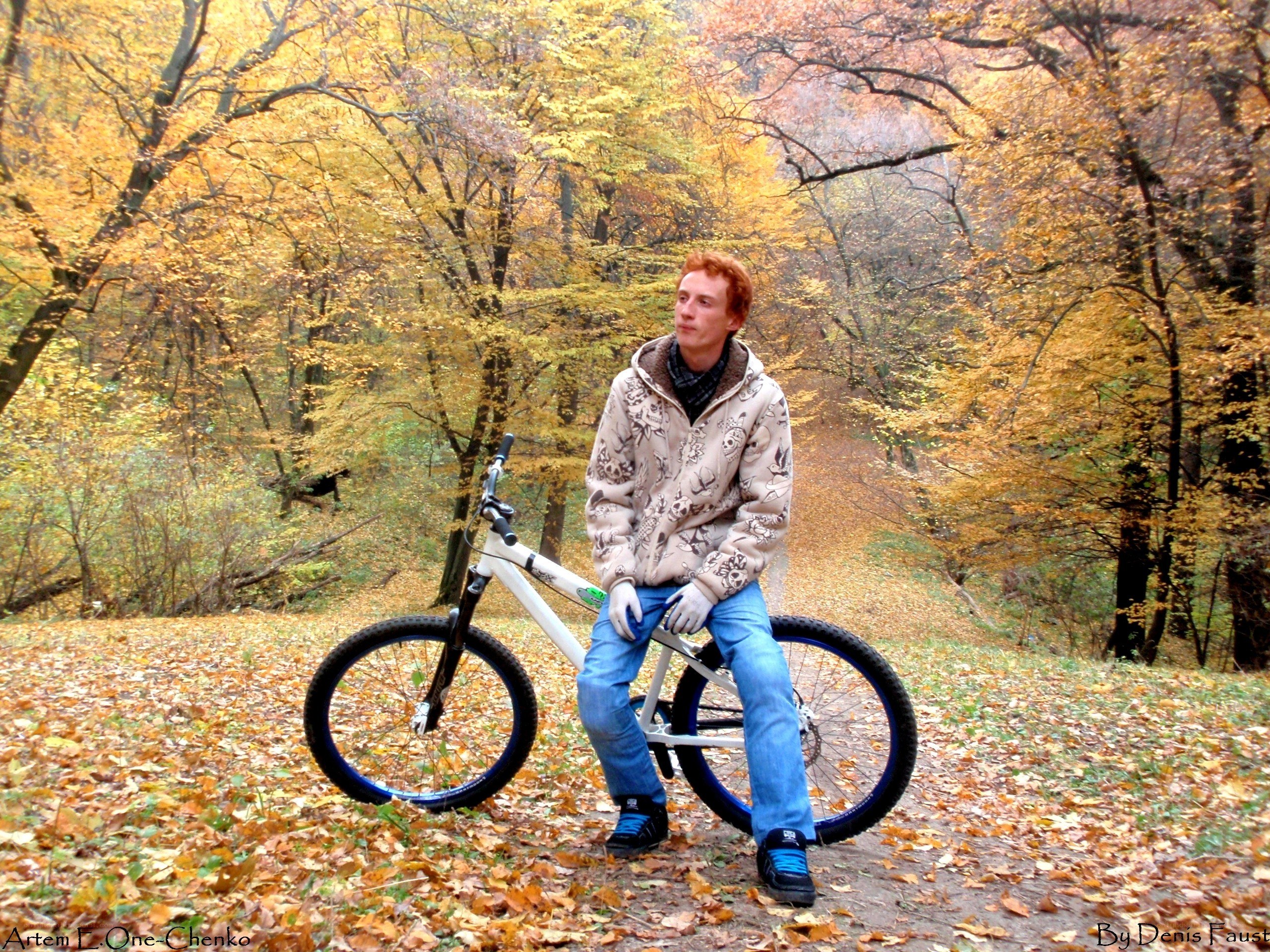 Man with bike in autumn forest