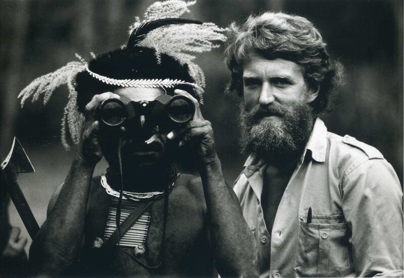 Man with binoculars and indigenous person