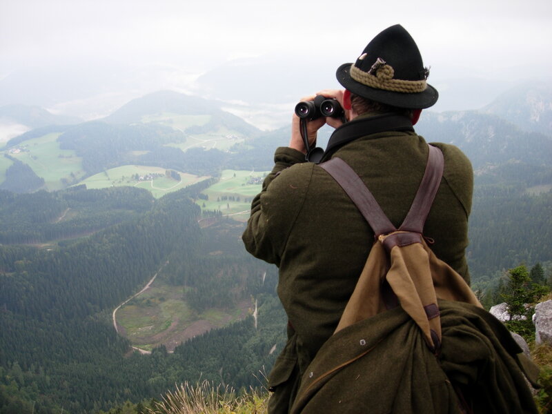 Man with binoculars on a mountain