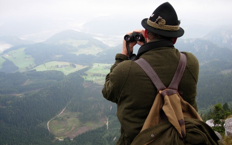 Man with binoculars on mountain
