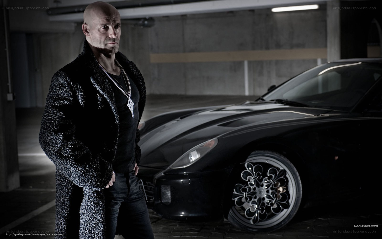 man with black car in garage